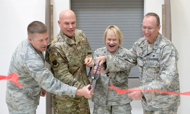 Col. Michael Manion, 2nd from the left, 55th Wing commander and 55th Medical Group leadership, cut the ribbon signifying the opening of the new satellite pharmacy located at the Offutt Air Force Base, Nebraska, Base Exchange. The pharmacy gained approximately thirty percent in square footage, giving them additional space not only to fill and manage prescriptions, but also for patient processing lines.