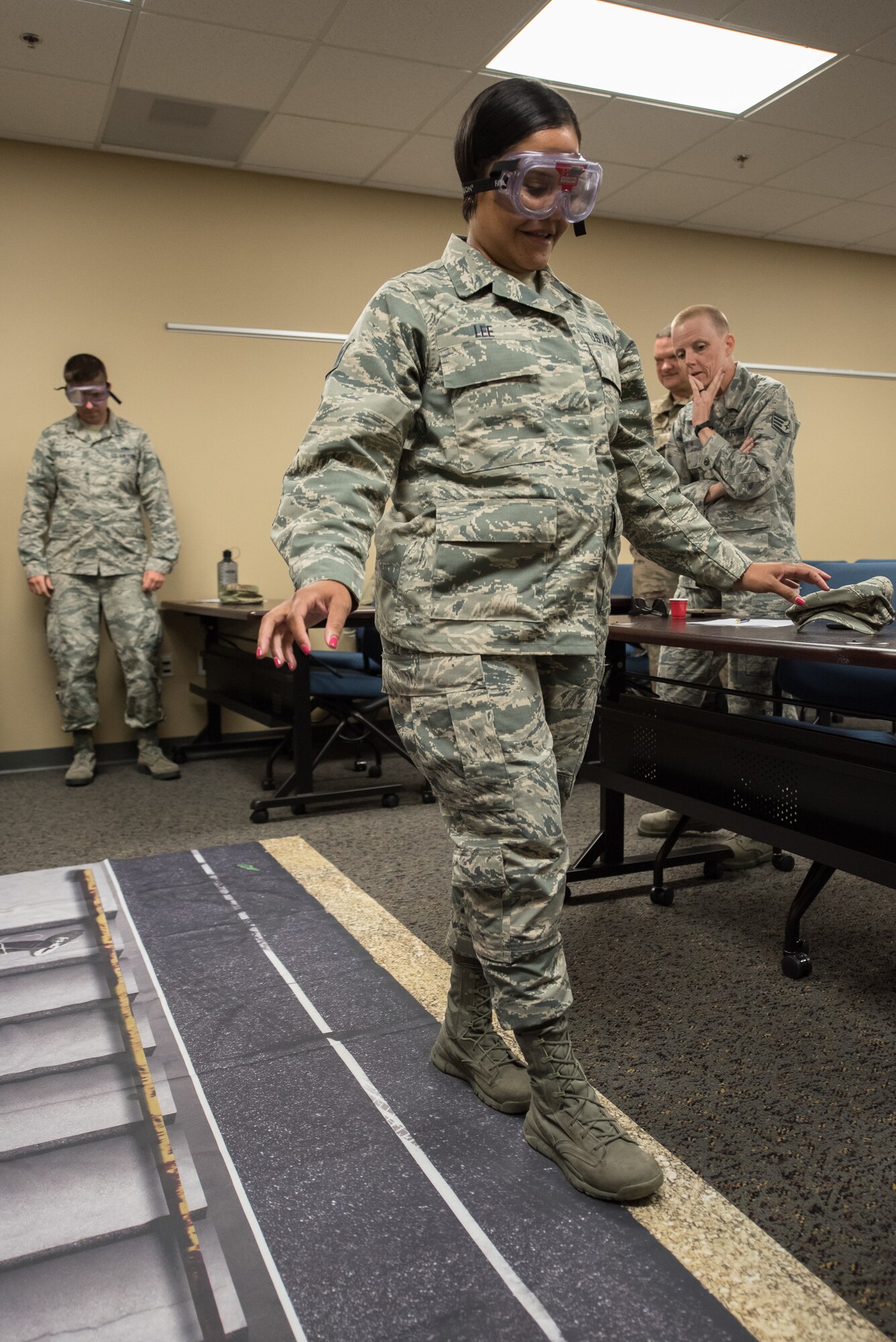 Staff Sgt. Erin Lee, a command support specialist in the Kentucky Air National Guard’s 123rd Airlift Wing, participates in a wellness class while wearing goggles to mimic the effects of alcohol impairment May 19, 2019, in Savannah, Ga. The class was part of Maintenance University, a four-day event held at the Combat Readiness Training Center from May 19 to 22.
