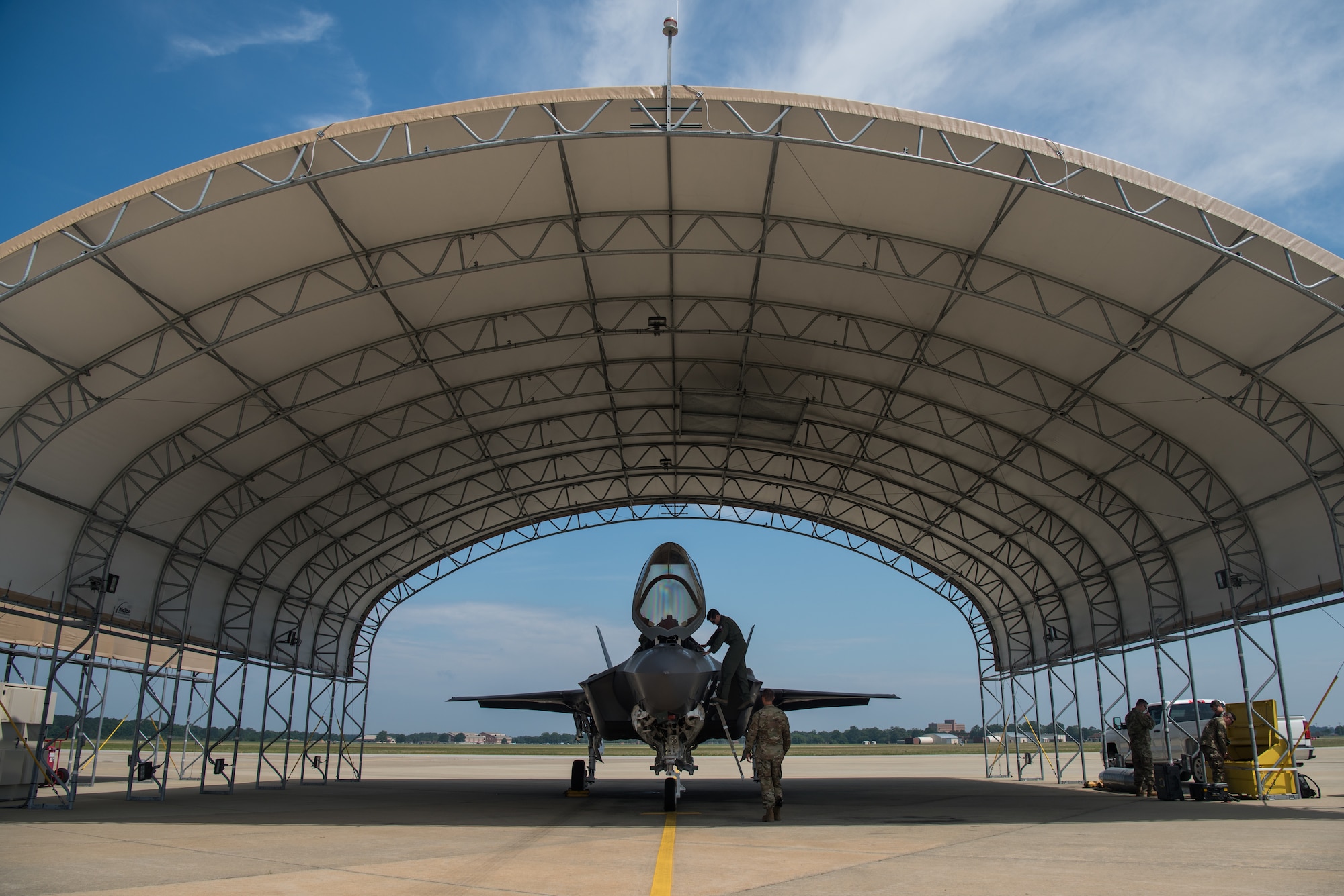 U.S. Air Force Capt. Andrew “Dojo” Olson, F-35 Lightning II Demonstration Team pilot, climbs up to check the cockpit before takeoff at Joint Base Langley-Eustis, Virginia, June 6, 2019.