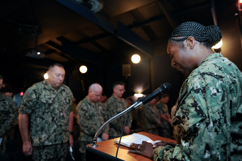 U.S. Navy Lt. Cmdr. Adrienne Benton, a chaplain assigned to the Naval Weapons Station, prays with the attending members during a Battle of Midway commemoration, June 6, 2019, at Joint Base Charleston’s Naval Weapons Station, S.C. The ceremony highlighted the contributions of U.S. Sailors to the success at Midway during World War II. The Battle of Midway took place between June 4, 1942, and June 7, 1942, six months after Japan's attack on Pearl Harbor. (U.S. Air Force photo by Senior Airman Thomas T. Charlton)