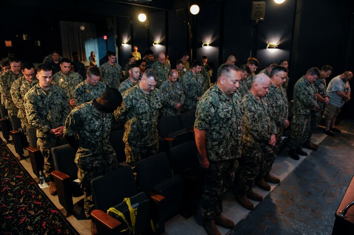Attendees bow their heads during a moment of silence at a Battle of Midway commemoration, June 6, 2019, at Joint Base Charleston’s Naval Weapons Station, S.C. The ceremony highlighted the contributions of U.S. Sailors to the success at Midway during World War II. The Battle of Midway took place between June 4, 1942, and June 7, 1942, six months after Japan's attack on Pearl Harbor. (U.S. Air Force photo by Senior Airman Thomas T. Charlton)