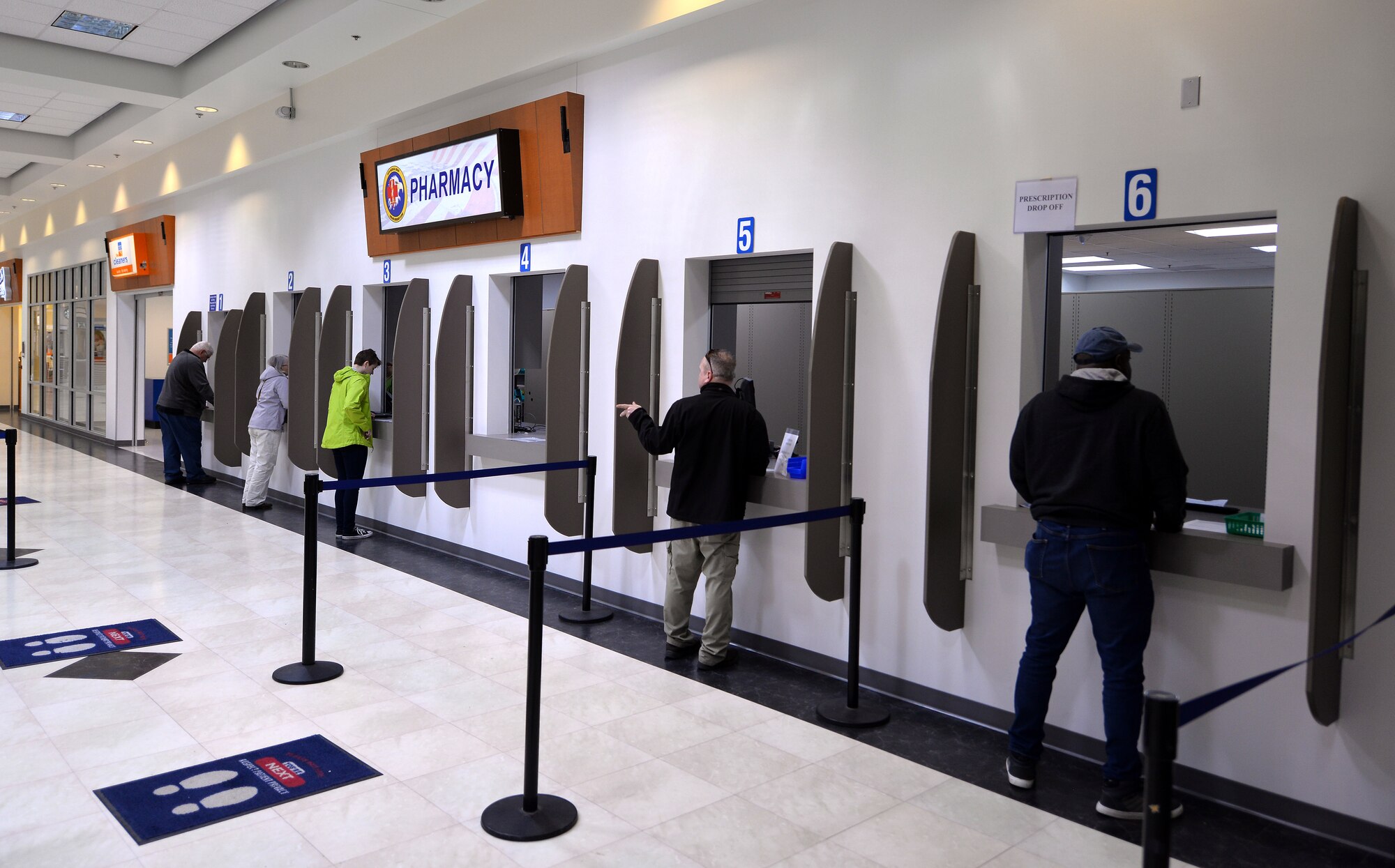 Patients drop off and pick up prescriptions May 8, 2019, at the new satellite pharmacy located in the north side of the Offutt Air Force Base, Nebraska Base Exchange. The pharmacy gained approximately 30 percent in square footage, providing additional space to fill and manage prescriptions. It now has six windows available, two windows for prescription drop-off, three windows for prescription pick-up and one window for consultation or questions.