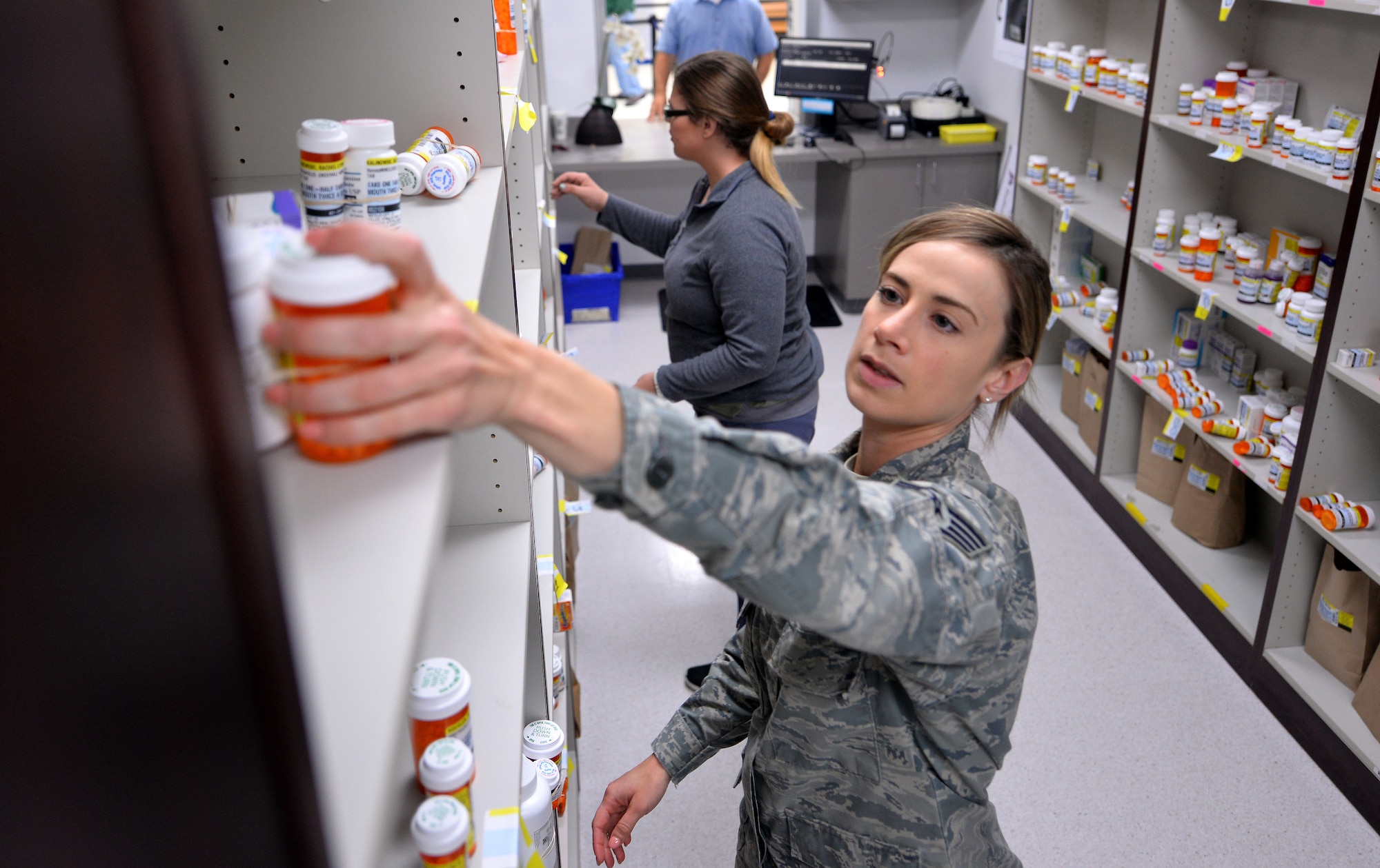 Staff Sgt. Lesley Smith, 55th Medical Support Squadron’s satellite pharmacy NCO in charge, reaches for a prescription May 8, 2019 at the new satellite pharmacy located in the north side the Offutt Air Force Base, Nebraska Base Exchange.