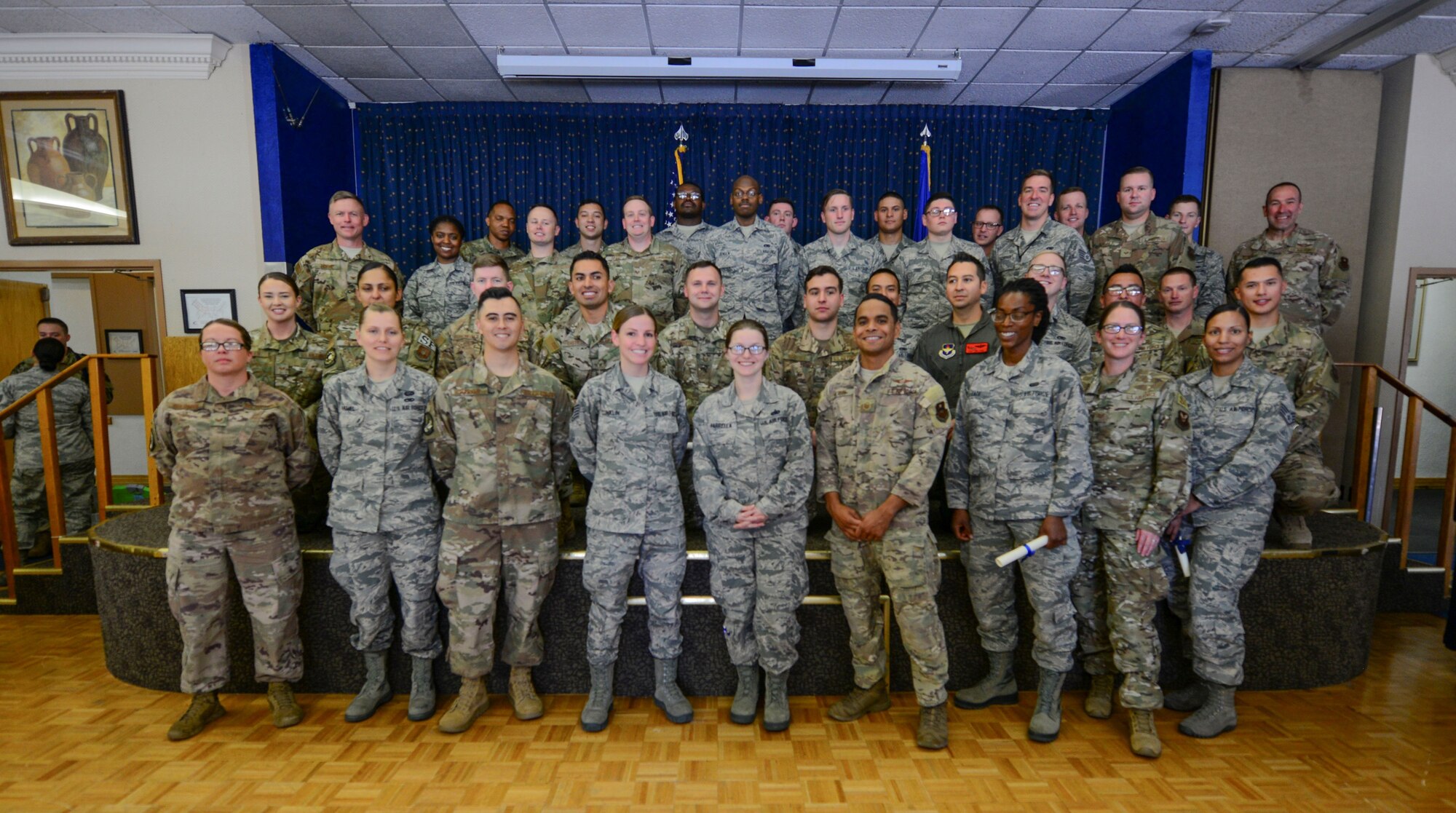 Community College of the Air Force (CCAF) graduates pose for a group photo after their graduation ceremony held at the Mountain View Club on June 5, 2019. Airmen must successfully complete technical training as well as additional classes outside of work in order to receive a CCAF degree. (U.S Air Force photo by Senior Airman Alexandria Crawford)