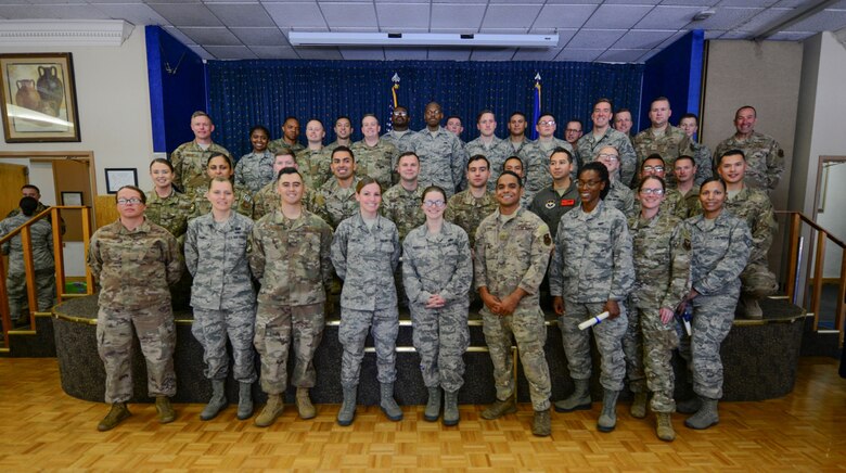 Community College of the Air Force (CCAF) graduates pose for a group photo after their graduation ceremony held at the Mountain View Club on June 5, 2019. Airmen must successfully complete technical training as well as additional classes outside of work in order to receive a CCAF degree. (U.S Air Force photo by Senior Airman Alexandria Crawford)