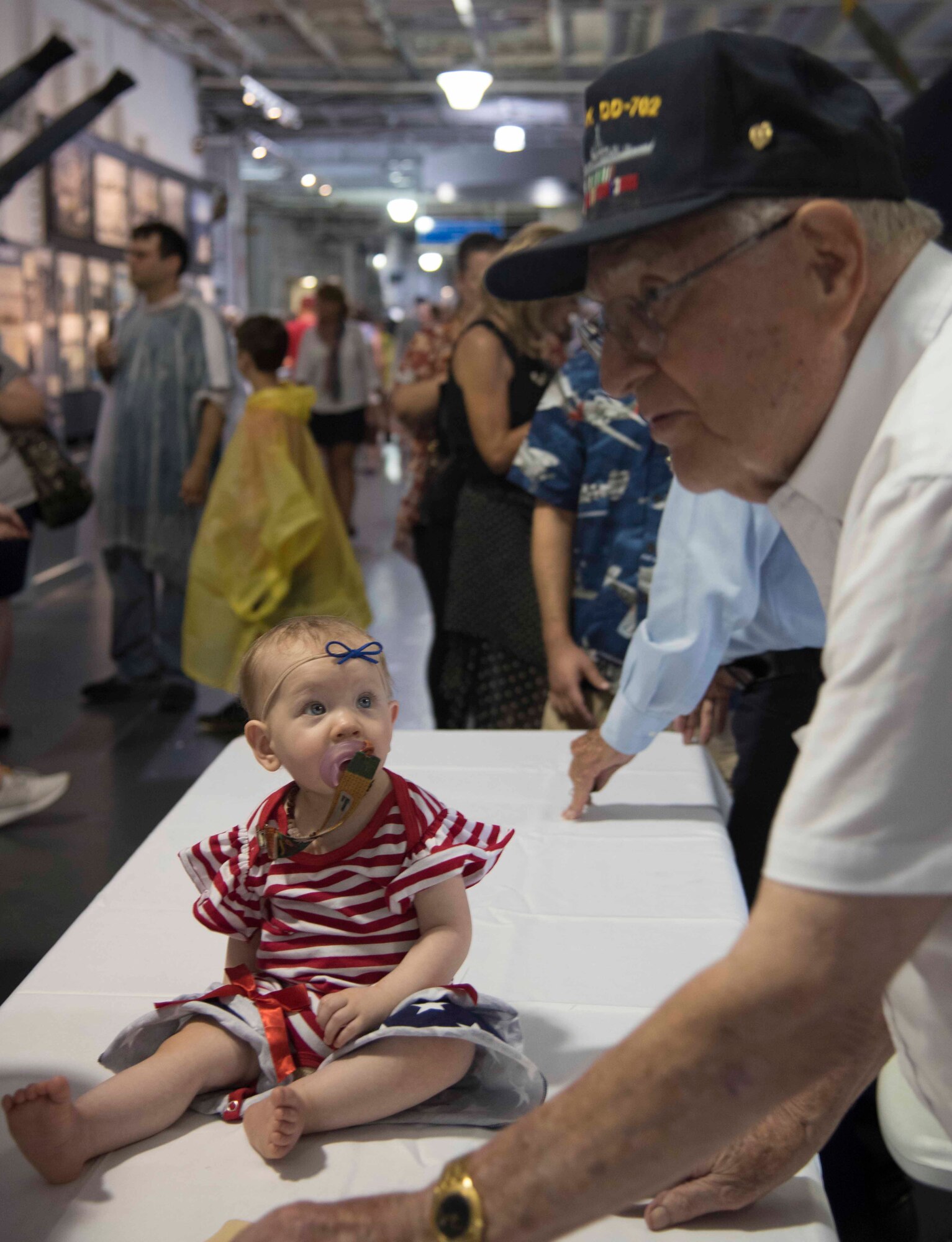 U.S. Navy D-Day Veteran, Seaman First Class Ted Teagle part of the USS Laffey Task Force, educates our youngest patron, June 6, 2019, at USS Yorktown, South Carolina. Hundreds of patrons came out to the Patriot Point 75th Anniversary of D-Day celebration to honor of the nine WWII Veterans, such as Teagle who joined the U.S. Navy at 15-years-old.