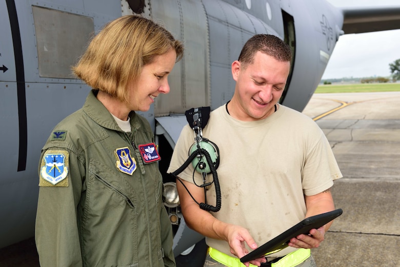 Col. Jennie R. Johnson, 403rd Wing commander, observes Staff Sgt. Alejandro Cano, 803rd Aircraft Maintenance Squadron aircraft hydraulics technician, perform an inspection on a C-130J Super Hercules Oct. 15, 2017.