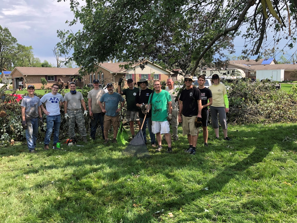 Air Force Research Laboratory employees take time to help colleagues clean up tornado damage. (U.S. Air Force Photo/Matt Berent)
