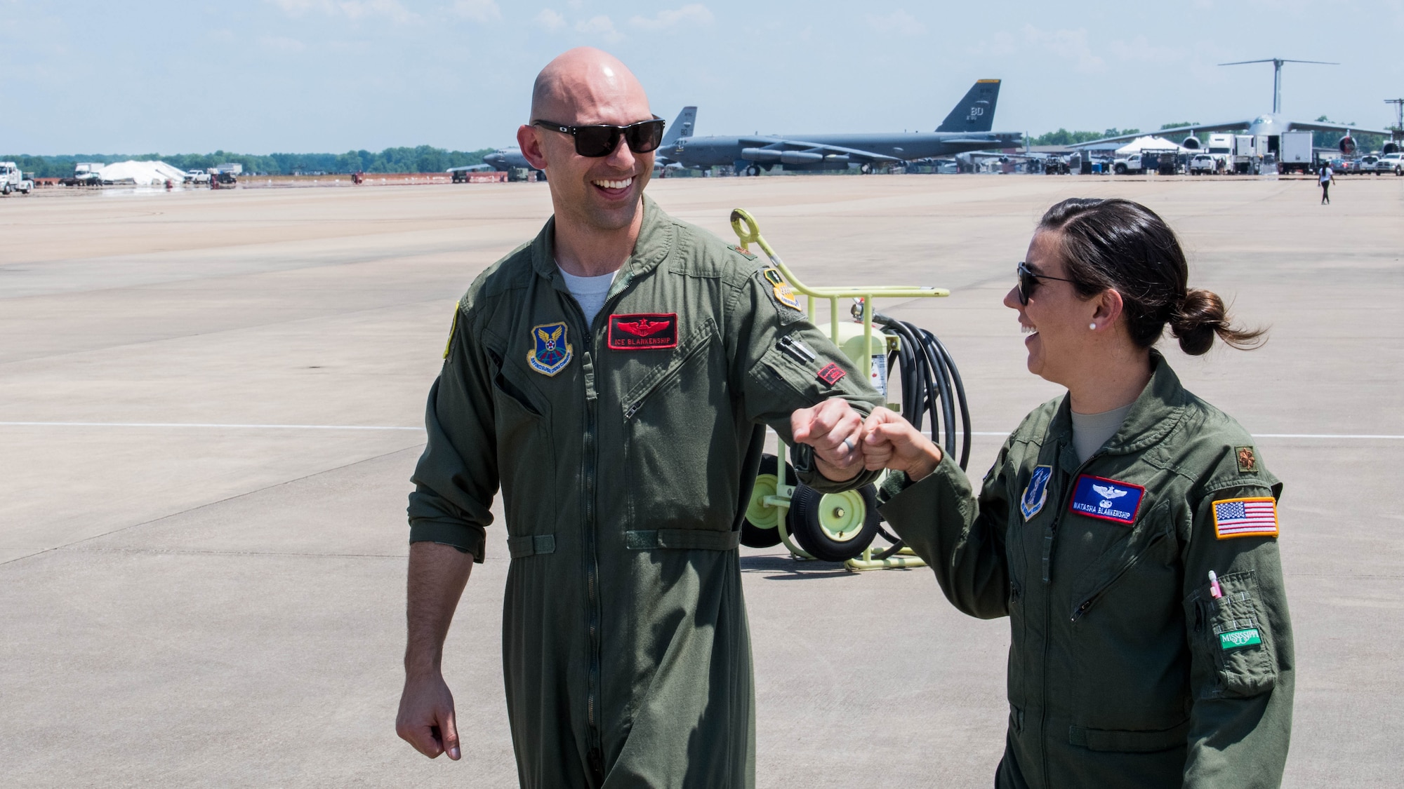 Maj. John R. Blankenship, a B-52 Stratofortress pilot with the 96th Bomb Squadron, and his wife Maj. Natasha E. Blankenship, a C-17 Globemaster III pilot with the 183rd Airlift Squadron in Jackson, Mississippi, gives each other a fist bump after Natasha Blankenship landed her aircraft to be put on display as apart of the Barksdale Defenders of Liberty Air Show at Barksdale Air Force Base, La., May 16, 2019. The Blankenships have a combined 10 deployments under their belts. (U.S. Air Force photo by Airman Jacob B. Wrightsman)