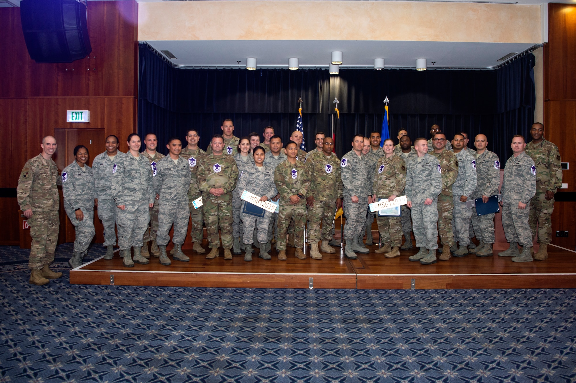 U.S. Air Force Col. Jason Bailey, 52nd Fighter Wing commander, far left, and Chief Master Sgt. Alvin Dyer, 52nd FW command chief, far right, pose for a photo with 52nd FW master sergeant selects during a release party at Spangdahlem Air Base, Germany, June 6, 2019. Family, friends and colleagues attended the event to celebrate the Airmen's promotion. (U.S. Air Force photo by Airman 1st Class Valerie Seelye)