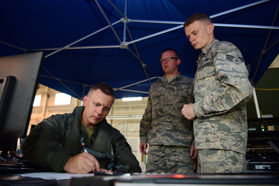 Senior Airmen Julian Cornwell and Justin Sauve, 388th Aircraft Maintenance Squadron debrief technicians, collects flight information from Lt. Col. Max Cover, 421st Fighter Squadron F-35A fighter pilot, during Astral Knight 2019 on June 3, 2019, at Aviano Air Base, Italy. The collected information was uploaded into the Autonomic Logistics Information System to maintain the F-35A’s mission readiness. The Airmen are deployed from the active duty 388th and Reserve 419th Fighter Wings at Hill Air Force Base, Utah. (U.S. Air Force photo by Tech. Sgt. Jim Araos)