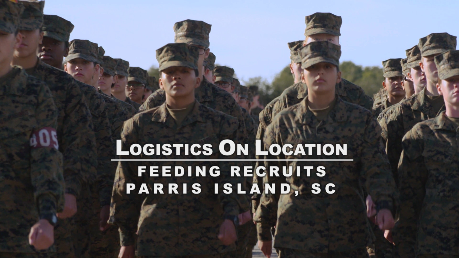 Marine recruits standing in formation looking forward with overlay title, Logistics On Location feeding recruits Parris Island, South Carolina.