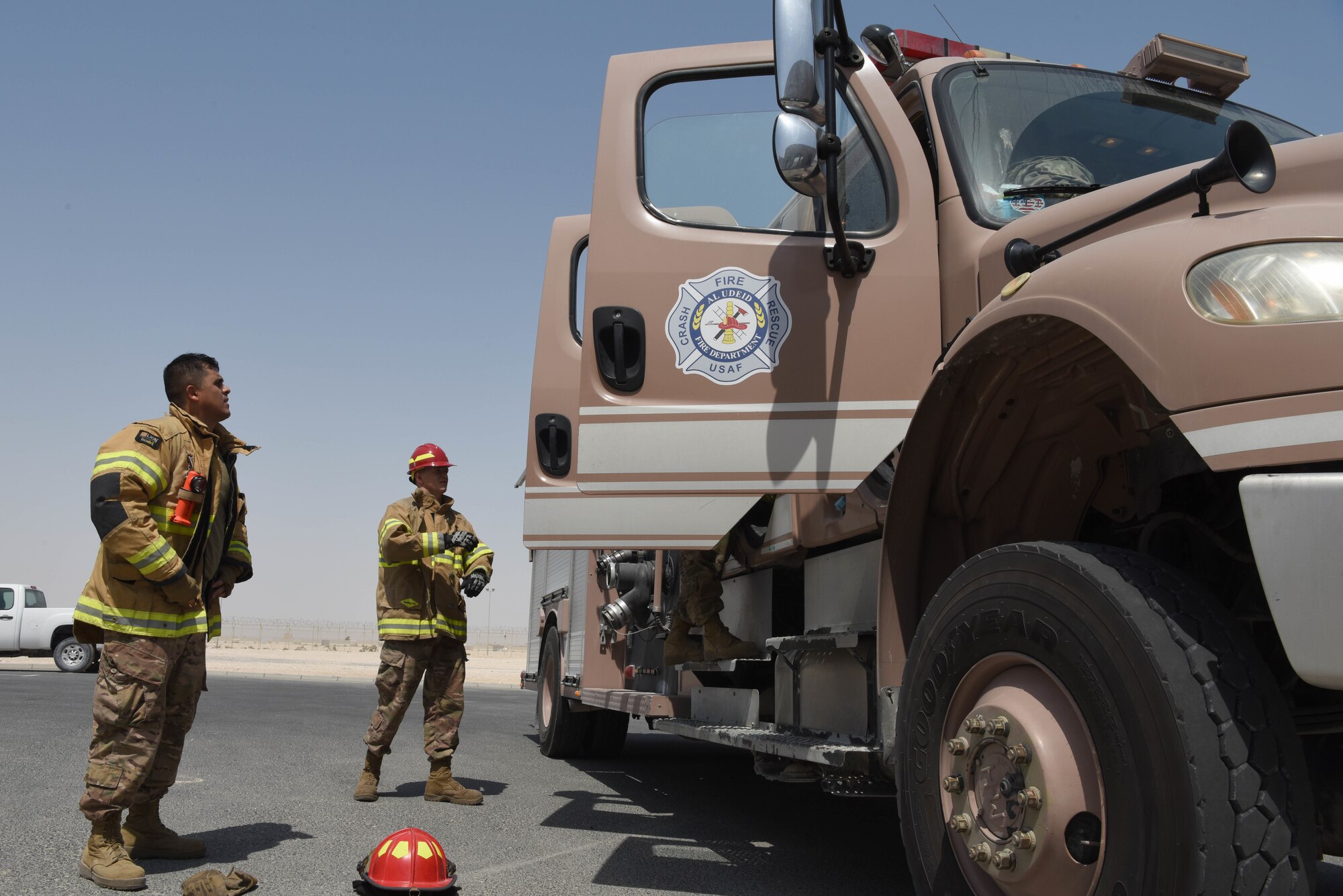 The 379th Expeditionary Civil Engineer Squadron Fire Station One Airmen put on personal protective equipment on June 6, 2019, at Al Udeid Air Base, Qatar. The 379th ECES fire department provides fire and emergency service where they protect lives and properties from fires. (U.S. Air Force photo by Staff Sgt. Ashley L. Gardner)