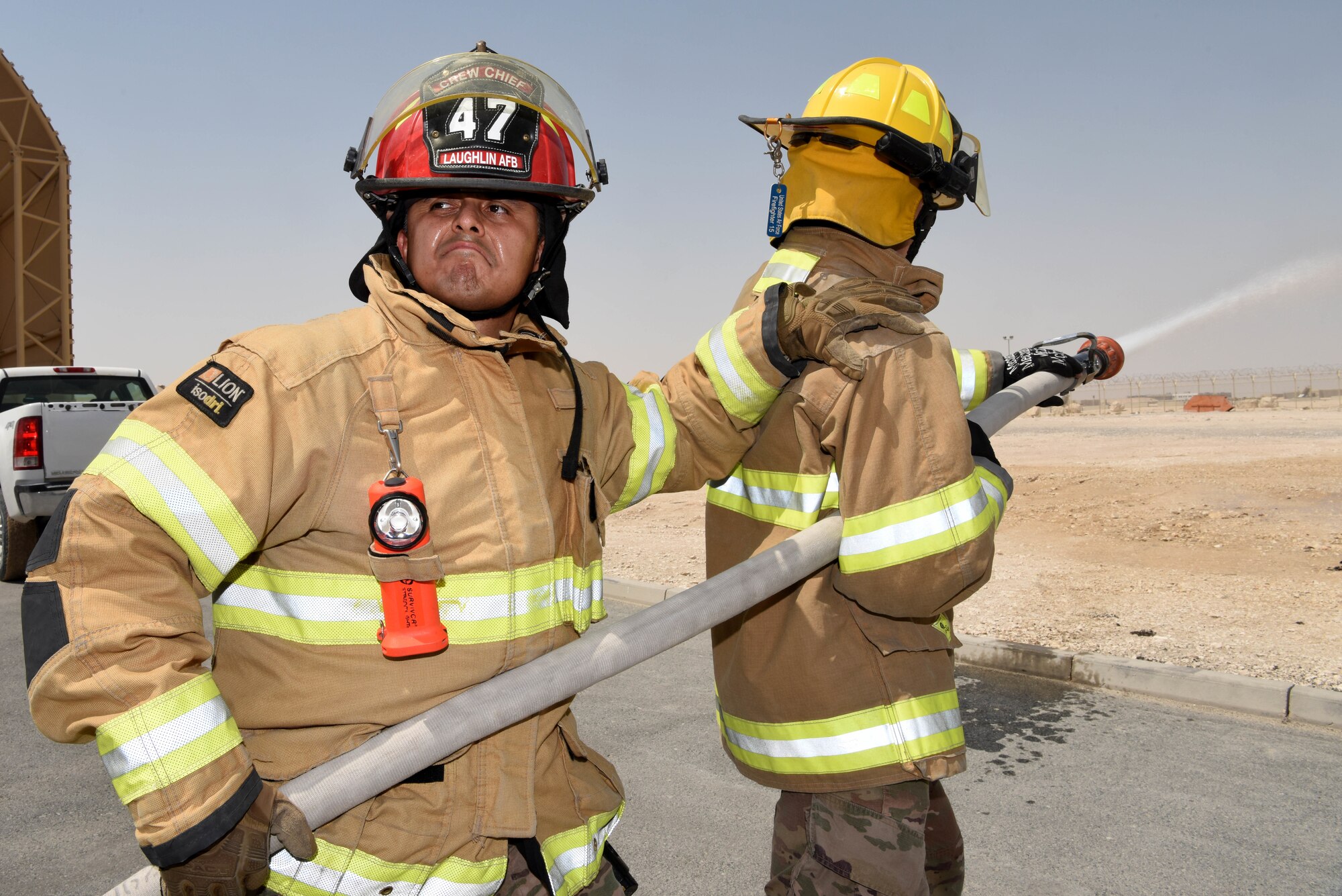 Tech. Sgt. Eduardo Castro, 379th Expeditionary Civil Engineer Squadron station captain and Airman 1st Class Samuel Olombo, 379th ECES firefighter tests function checks a fire truck on June 6, 2019, at Al Udeid Air Base, Qatar. During the function checks they also inspect and start the truck to ensure the vehicle is ready for use.  (U.S. Air Force photo by Staff Sgt. Ashley L. Gardner)