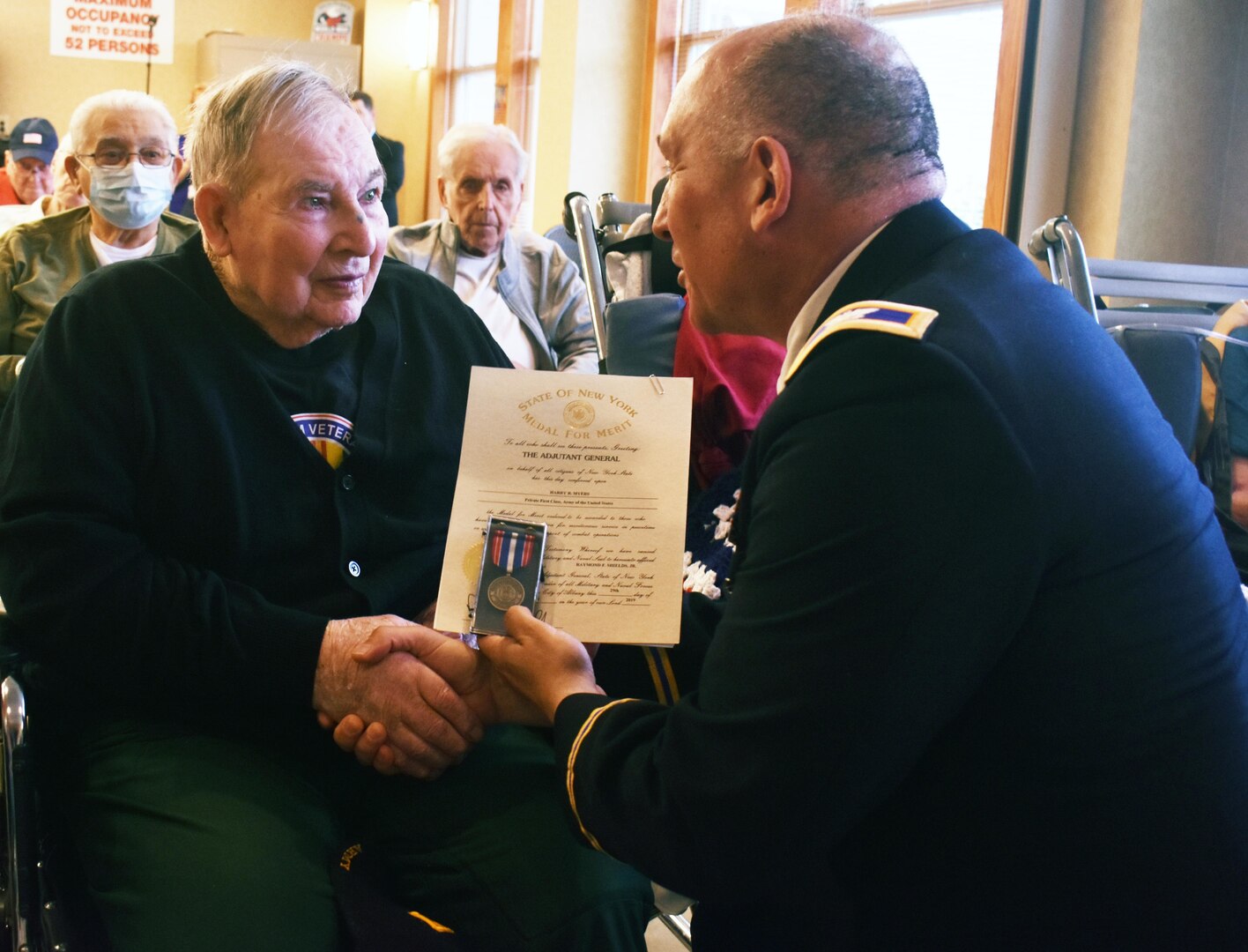 New York Army National Guard Col. Richard Goldenberg presents former Army  Pfc. and World War Ii veteran  Harry Myers with a New York State Medal of Merit at the 75th Anniversary of D-Day commemorative celebration at the Veterans’ Home in Oxford, N.Y., on June 6th, 2019.