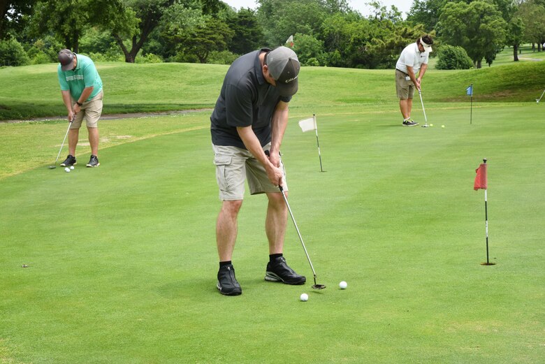 Participants of the 72nd Air Base Wing Golf Tournament practiced their best putts on the putting green at the Tinker Golf Course May 23. (U.S. Air Force photo/Kelly White)
