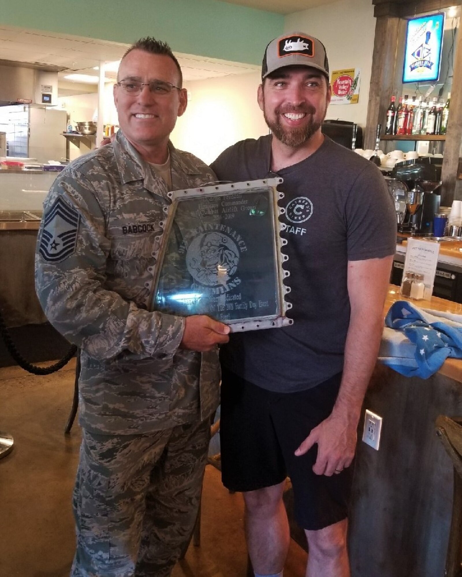 Chief Ralph Babcock, 913th Maintenance Squadron superintendent, presents a token of appreciation to Chef Donnie Ferneau, 913th Airlift Group Honorary Commander, on May 17, 2019 at Cathead's diner in Little Rock, Arkansas.