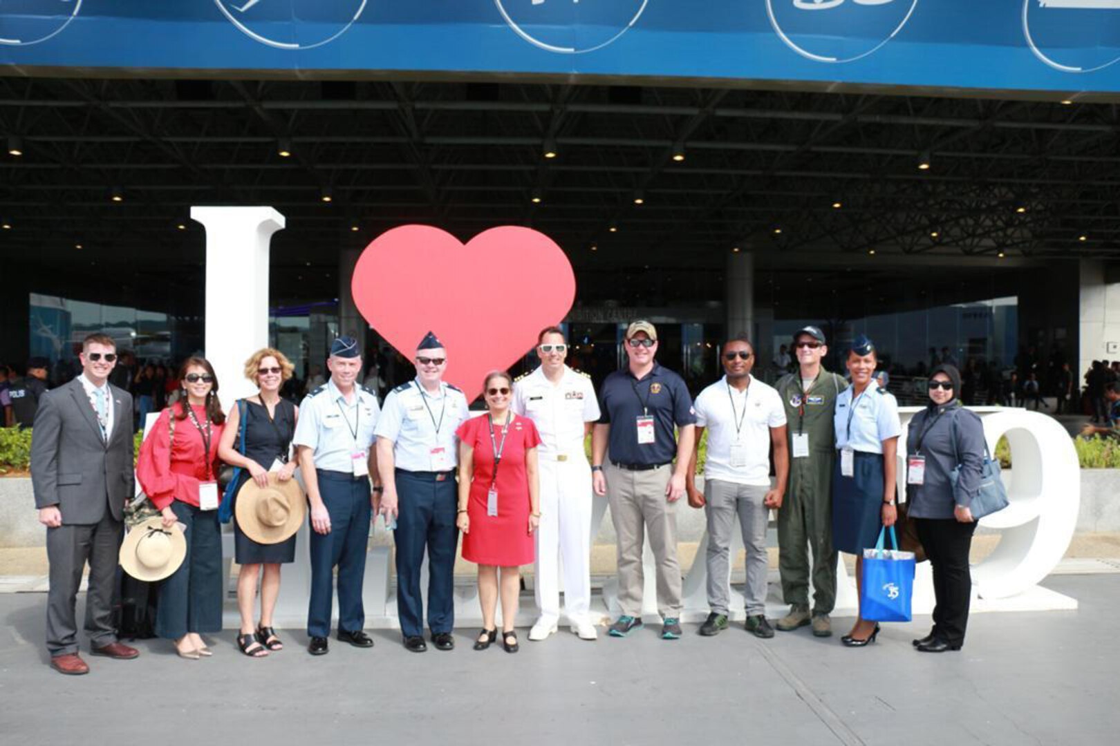 Maj. Chyteira Dues, Washington National Guard Malaysian Bilateral Affairs Officer, is pictured holding a bag with the U.S. delegation at the Langkawi International Maritime and Aerospace Exhibition March 2019, which included Kamala Shirin Lakhdhir, the United States Ambassador to Malaysia, Brig. Gen. Jeremy Horn, commander of the Washington Air National Guard, and her U.S. Embassy in Malaysia and Washington Air National Guard colleagues.