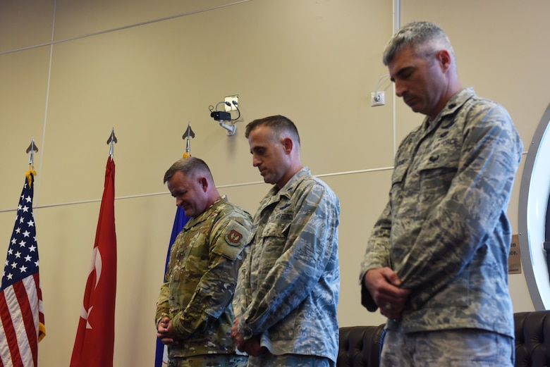 Group and squadron commanders participate in an invocation before the 39th Operations Support Squadron change of command ceremony June 6, 2019, at Incirlik Air Base, Turkey. During change of command ceremonies, the invocation traditionally takes place in between the national anthem and the opening remarks from the presiding officer. (U.S. Air Force photo by Senior Airman Joshua Magbanua)