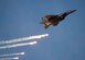 An F-15E Strike Eagle shoots out flares