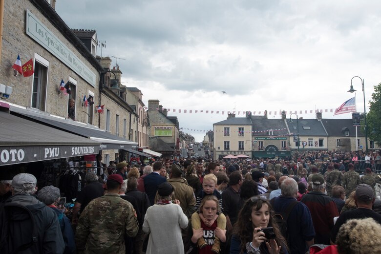 People gather in the village square of Sainte-Mère-Église, France, June 6, 2019, to celebrate freedom and honor all service members who fought for it on D-Day, 75 years ago. To commemorate the 75th anniversary of D-Day, the village square was filled with events ranging from an 82nd Airborne ceremony to several C-130J Super Hercules flyovers. (U.S. Air Force photo by Senior Airman Kristof J. Rixmann)