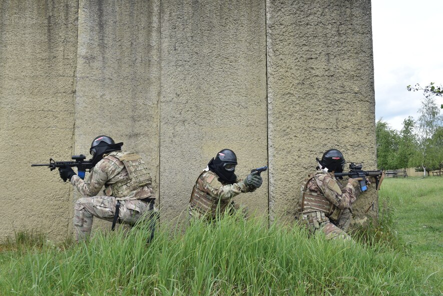 Security Forces Airmen discuss a plan of action before a dry-run exercise engaging simulated enemy combatants