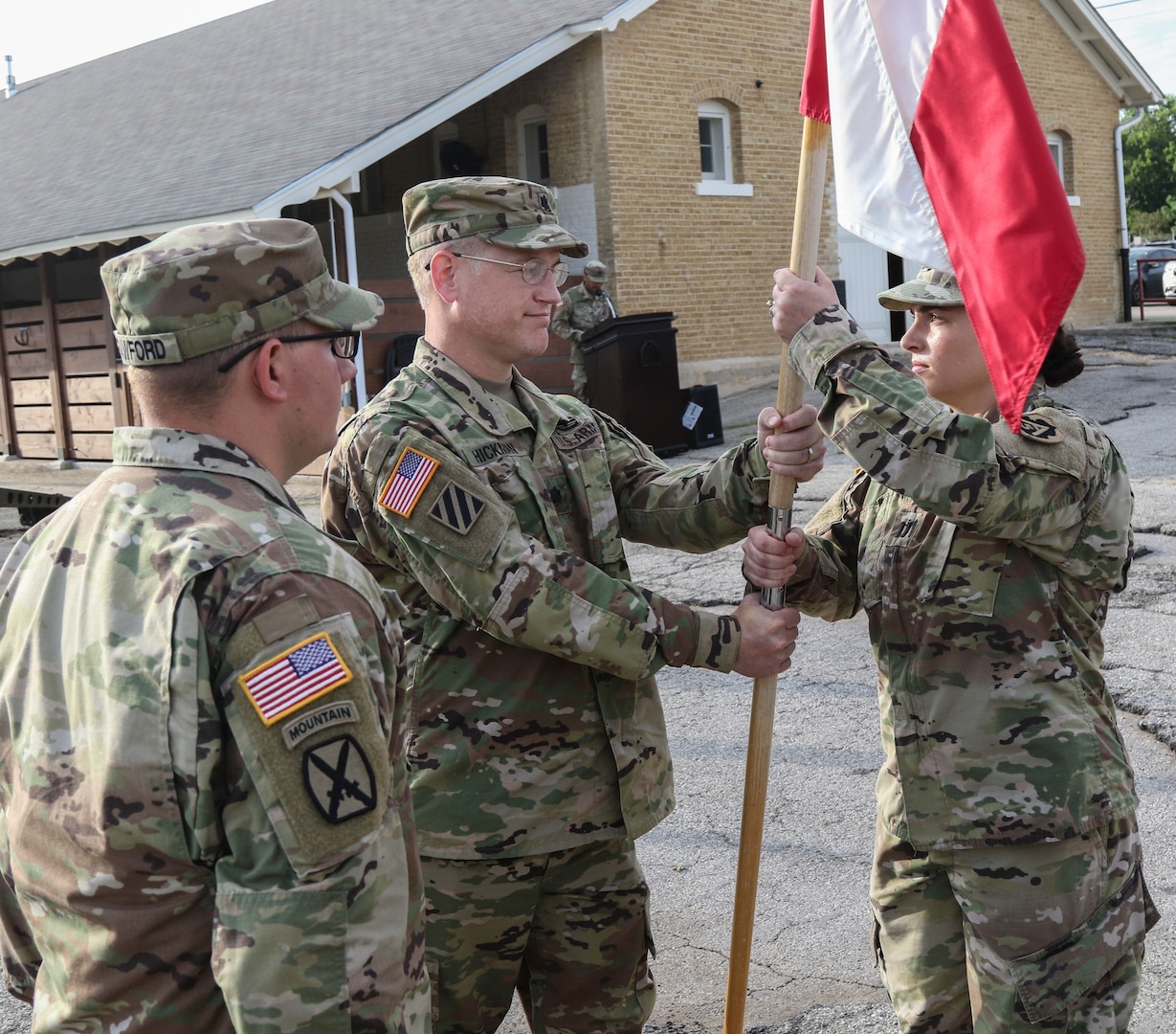 Lt. Col. Timothy Hickman (center), U.S. Army North Headquarters and Headquarters Battalion commander, passes the guidon representing the ARNORTH Headquarters Support Company to the incoming commander, Capt. Stephanie E. Hecker (right), during a change of command ceremony at the Joint Base San Antonio-Fort Sam Houston stables June 3.