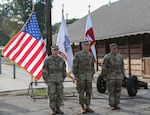 Lt. Col. Timothy Hickman (center), U.S. Army North Headquarters and Headquarters Battalion commander, stands at attention with Capt. Adam C. Crawford (right), outgoing commander for the ARNORTH Headquarters Support Company, and Capt. Stephanie E. Hecker (left), incoming commander for HSC, after the passing of the guidon during a change of command ceremony at the Joint Base San Antonio-Fort Sam Houston stables June 3. The change of command ceremony represents the passing of responsibilities for a unit from the outgoing commander to the incoming commander.