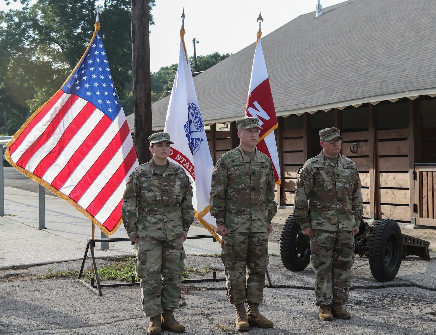 Lt. Col. Timothy Hickman (center), U.S. Army North Headquarters and Headquarters Battalion commander, stands at attention with Capt. Adam C. Crawford (right), outgoing commander for the ARNORTH Headquarters Support Company, and Capt. Stephanie E. Hecker (left), incoming commander for HSC, after the passing of the guidon during a change of command ceremony at the Joint Base San Antonio-Fort Sam Houston stables June 3. The change of command ceremony represents the passing of responsibilities for a unit from the outgoing commander to the incoming commander.