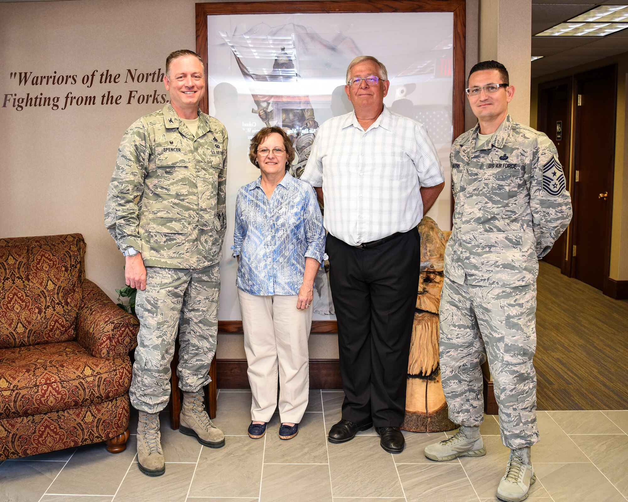 Col. Benjamin Spencer, 319th Air Base Wing commander, and CMSgt Ryan Thuyns, 319 ABW command chief, recognize Patricia Wacek, Gold Star Family Member, and Kevin Wacek, her spouse, June 7, 2019 during a tour at Grand Forks Air Force Base, North Dakota. Gold Star Family Members are immediate family members of service members who were killed in combat, through an act of terrorism, declared missing in action or a prisoner war. (U.S. Air Force photo by Senior Airman Elijaih Tiggs)