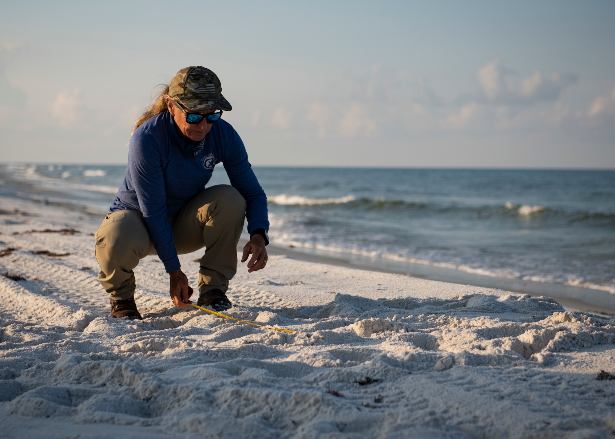 Rebecca Johnson, Tyndall Natural Resources wildlife and biological technician, measures the width of a sea turtle path on the beach at Tyndall Air Force Base, Florida, June 5, 2019.