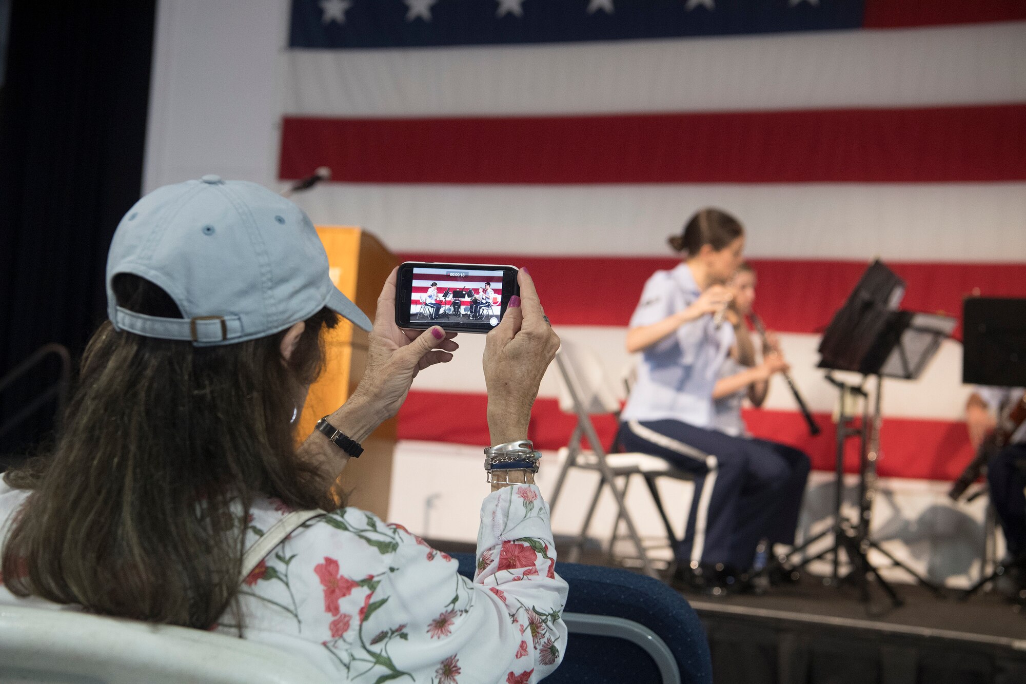 Delores Goodwin, retired teacher and audience member, takes a video of the U.S. Air Force Heritage Winds June 6th, 2019, in Mount Pleasant, S.C.
