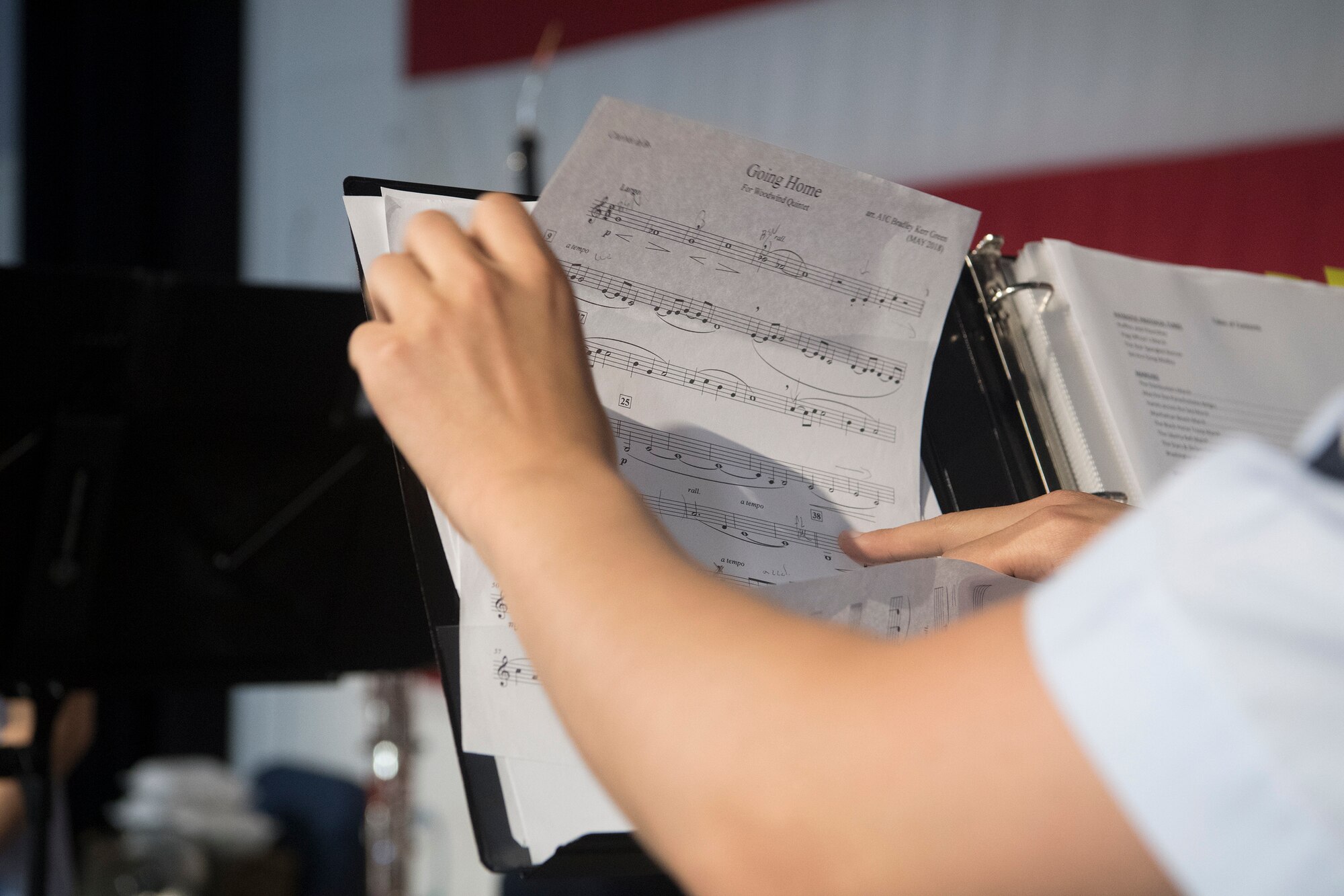Airman 1st Class Louis Kim, a clarinet player with the U.S. Air Force Heritage Winds, changes his sheet music during a performance June 6th, 2019 in Mount Pleasant, S.C.