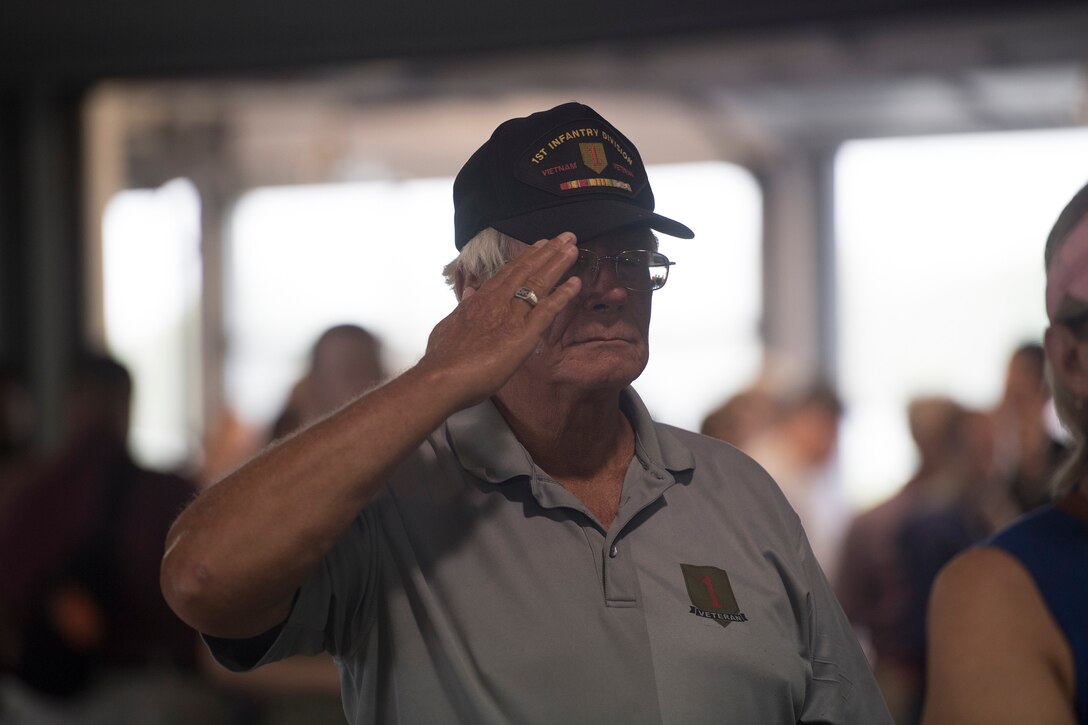 A Vietnam veteran salutes the flag during the National Anthem before a U.S. Air Force Heritage Winds concert June 6th, 2019, in Mount Pleasant S.C.