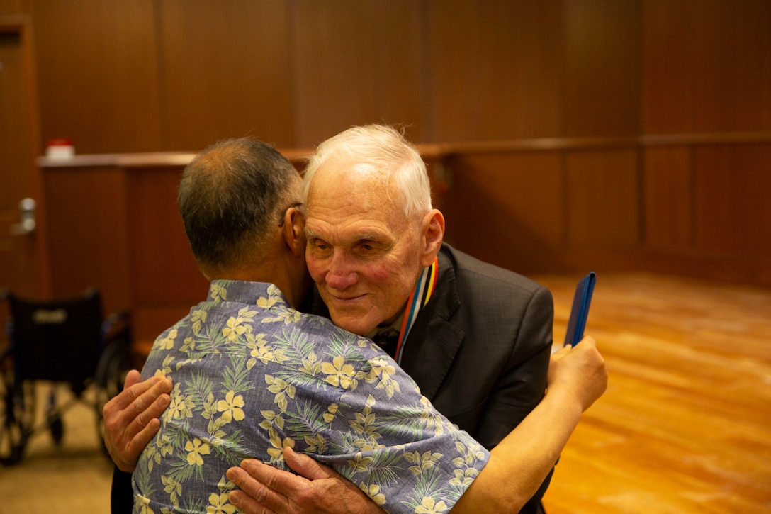 Robert W. Loney, right, a Korean War veteran, hugs his long time friend Paul Yoon from Korea, during an award ceremony at Marine Corps Support Facility New Orleans, June 7, 2019. Loney was presented the Ambassador of Peace Medal for his outstanding service during the Korean War. (U.S. Marine Corps photo by Lance Cpl. Samwel J. Tabancay)