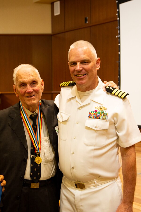 U.S. Navy Capt. Timothy J. Loney, right, deputy force chaplain, Marine Forces Reserve, poses with his father Robert W. Loney, left, a Korean War veteran, during an award ceremony at Marine Corps Support Facility New Orleans, June 7, 2019. Capt. Loney presented his father the Ambassador of Peace Medal for his outstanding service in the U.S. Army Signal Corps during the Korean War. (U.S. Marine Corps photo by Lance Cpl. Samwel J. Tabancay)