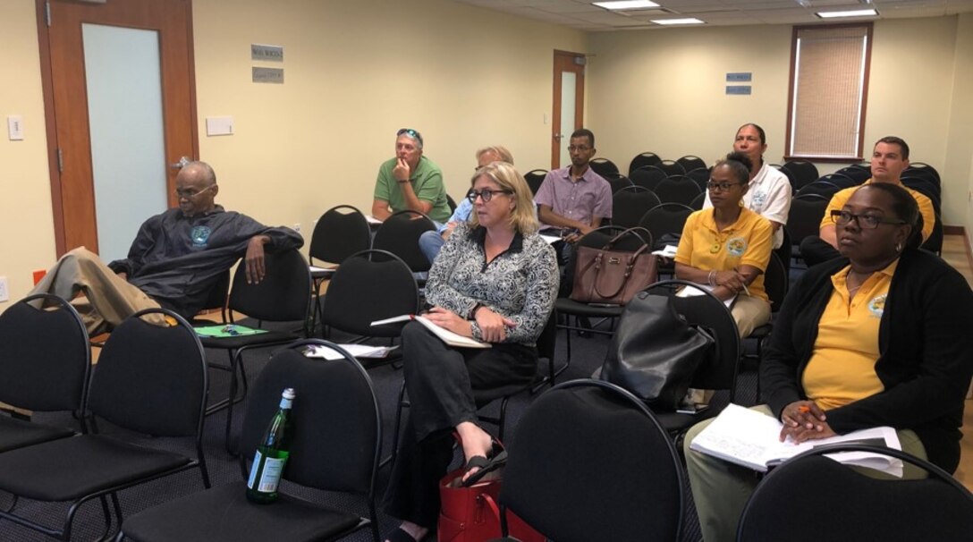 People sitting in a conference room listening to a presentation