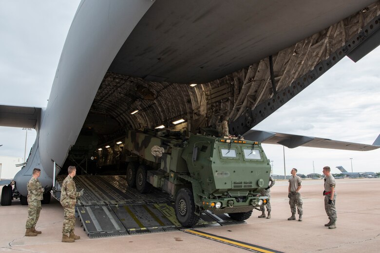 U.S. Air Force Airmen assigned to the 58th Airlift Squadron work with soldiers from the Oklahoma Army National Guard to load personnel and four High-Mobility Artillery Rocket Systems (HIMARS) into a C-17 Globemaster III, June 3, 2019, at Altus Air Force Base, Okla. The 97 Air Mobility Wing teamed up with the brigade for an exercise to simulate deployed operations when overseas in real-world scenarios. (U.S. Air Force photo by Airman 1st Class Breanna Klemm)