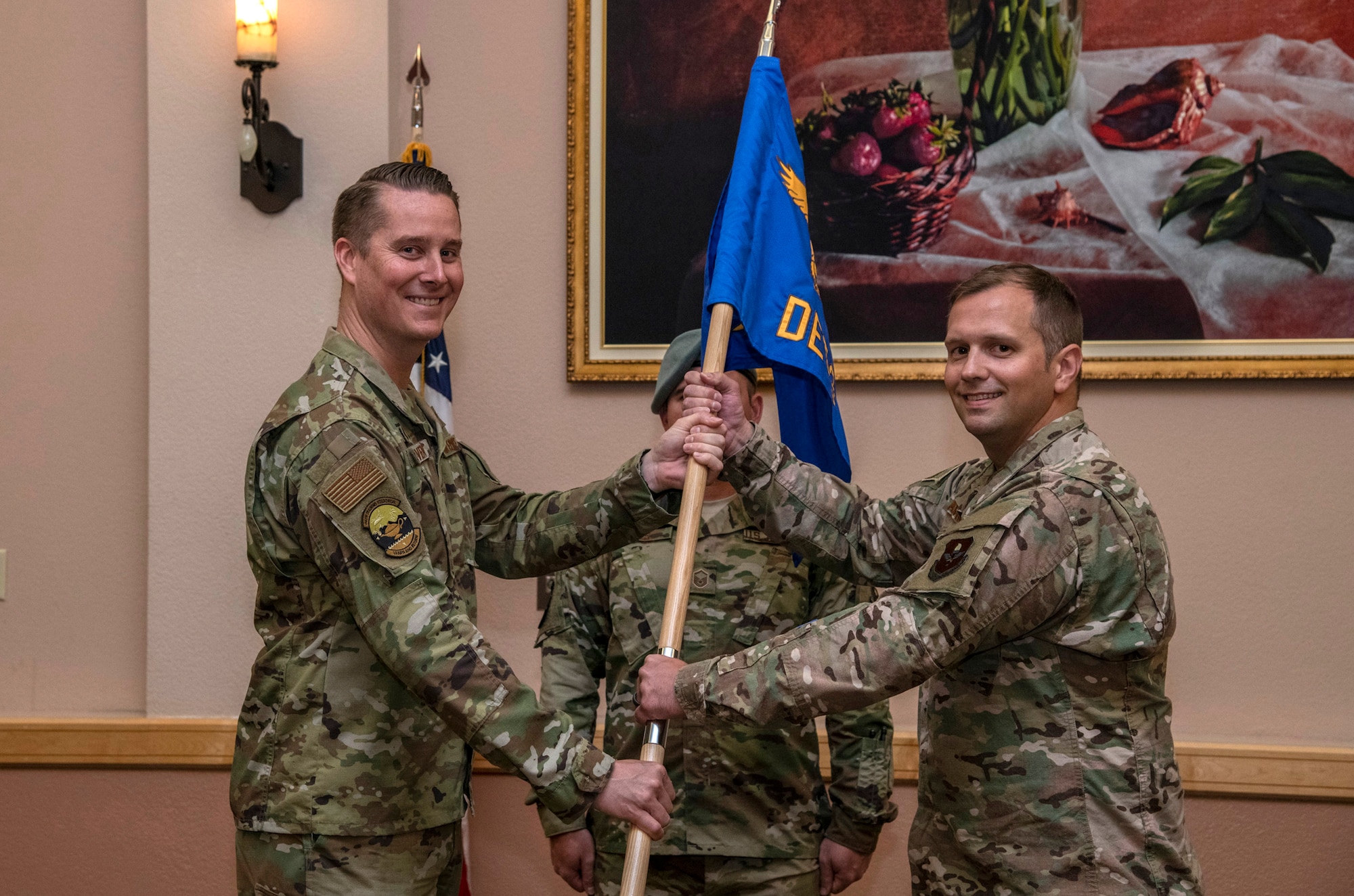 U.S Air Force Lt. Col. Andrew P. Berven, 66th Training Squadron commander, passes the guidon to Maj. Toby A. Andrews, assuming command, during the 66th TRS, Detachment 3, change of command ceremony June 7, 2019, at Joint Base San Antonio-Lackland, Texas. The 66th TRS, Detachment 3, is responsible for providing environmentally specific trained and globally qualified Airmen in Survival, Evasion, Resistance and Escape (SERE) courses.  The detachment selects and trains over 6,000 pipeline technical training Airmen a year in the proper use of principles, techniques, equipment, and procedures necessary to survive anywhere in the world. (U.S. Air Force photo/Johnny Saldivar)