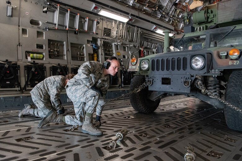U.S. Air Force Airmen from the 58th Airlift Squadron secure a High-Mobility Artillery Rocket Systems (HIMARS) inside a C-17 Globemaster III, June 3, 2019, at Altus Air Force Base, Okla. Together, the 58 AS and members of the Oklahoma Army National Guard participated in an Emergency Deployment Readiness Exercise testing the capabilities of both military branches to efficiently mobilize ground equipment and troops at a moment’s notice. (U.S. Air Force photo by Airman 1st Class Breanna Klemm)
