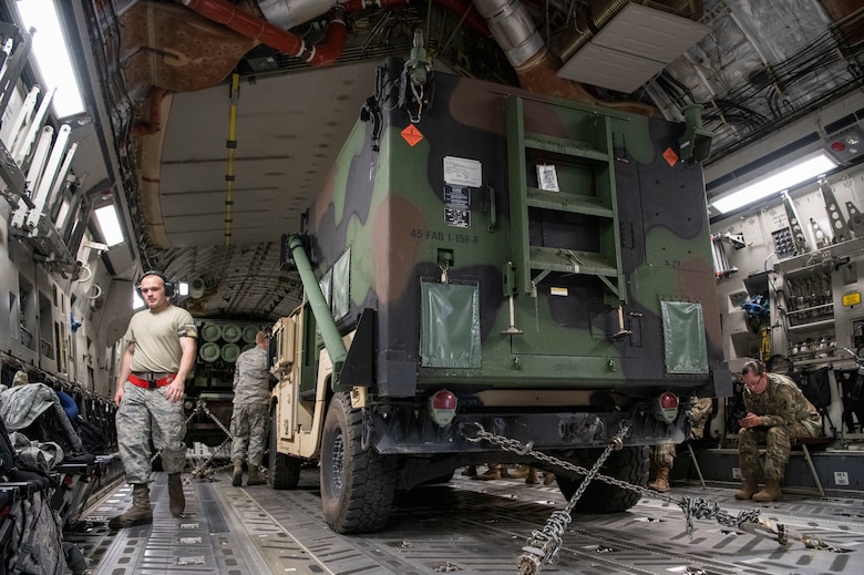 A High-Mobility Artillery Rocket Systems (HIMARS) is secured inside a C-17 Globemaster III, June 3, 2019, at Altus Air Force Base, Okla. The 97th Air Mobility Wing participates in joint exercises in order to improve their efficiency when working with other military branches. (U.S. Air Force photo by Airman 1st Class Breanna Klemm)