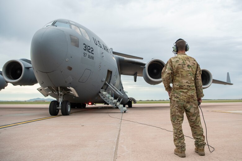 U.S. Air Force Staff Sgt. Drew Casburn, a 58th Airlift Squadron Loadmaster, inspects engines on a C-17 Globemaster III before takeoff, June 3, 2019, at Altus Air Force Base, Okla. The 58th AS helped load equipment onto the C-17 for an Emergency Deployment Readiness Exercise with the Oklahoma Army National Guard. (U.S. Air Force photo by Airman 1st Class Breanna Klemm)