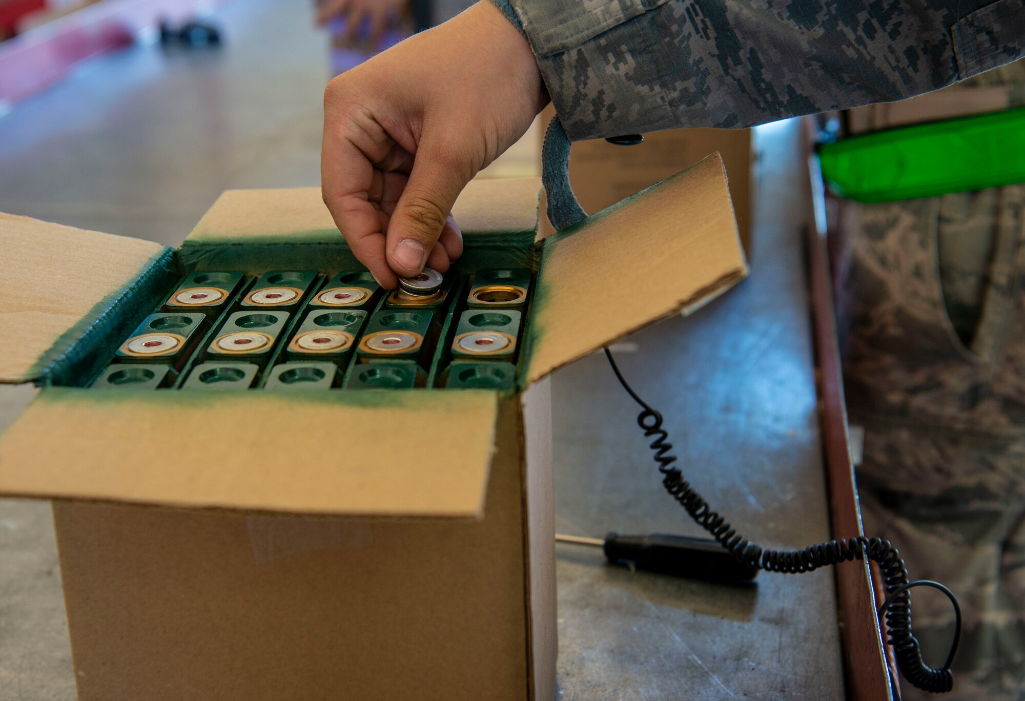 U.S. Air Force Airman 1st Class William Dean, 57th Munitions Squadron line delivery technician, removes the impulse cart for inspection to be reinserted into the flare sticks at Nellis Air Force Base, Nev., June 4, 2019. While inspecting the flare sticks, Dean and other line delivery Airmen wear a band that grounds their hands to a copper wire to ensure no electric spark set off the flares. (U.S. Air Force photo by Staff Sgt. Tabatha McCarthy)