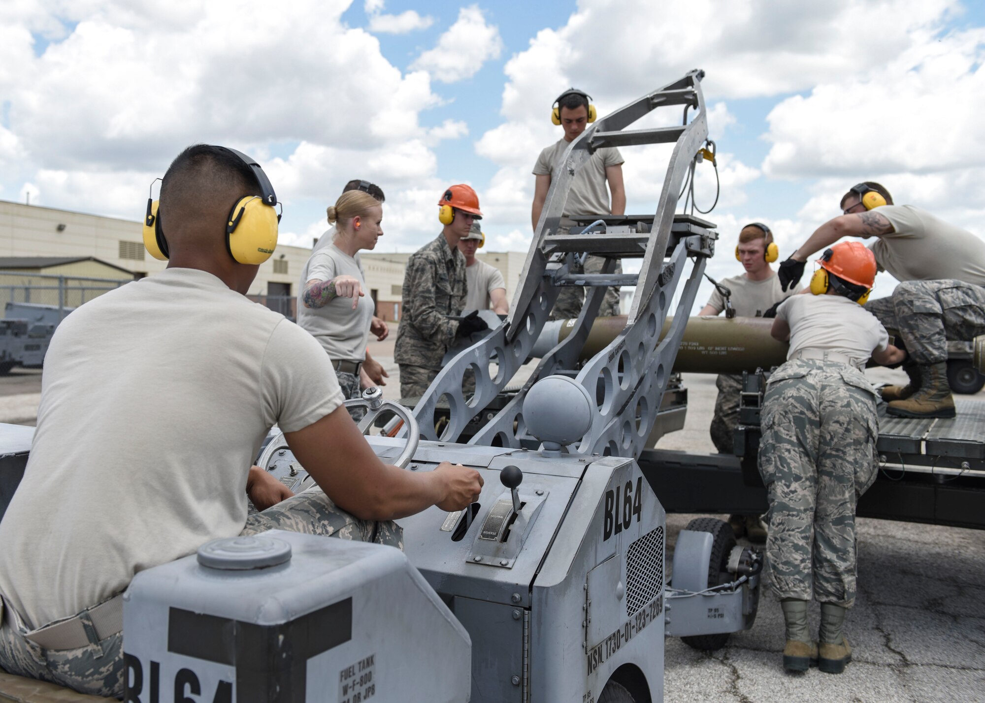 363rd Training Squadron munitions apprentice course students load a Mark 82 training bomb onto a trailer at Sheppard Air Force Base, Texas, June 7, 2019. The students are training to preform a crossload where they will transfer the training bomb from one trailer to another, due to the trailer either being inoperative and or to another trailer due to mission requirements. This training also allows the students to get comfortable with the idea and process of working with a fragile workload. (U.S. Air Force photo by Senior Airman Ilyana A. Escalona)