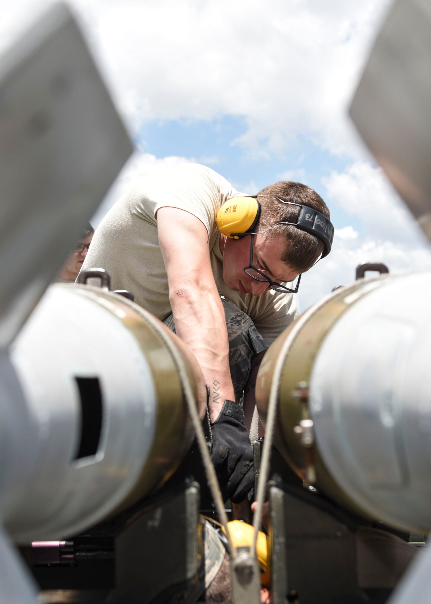 A 363rd Training Squadron munitions apprentice course student secures a Mark 82 training bomb to a trailer while at Sheppard Air Force Base, Texas, June 7, 2019. The student is preforming a crossload, where bombs are transferred from one trailer to another, due to the trailer either being inoperative and or to another trailer due to mission requirements. This training also allows the students to get comfortable with the idea and process of working with a fragile workload. (U.S. Air Force photo by Senior Airman Ilyana A. Escalona)