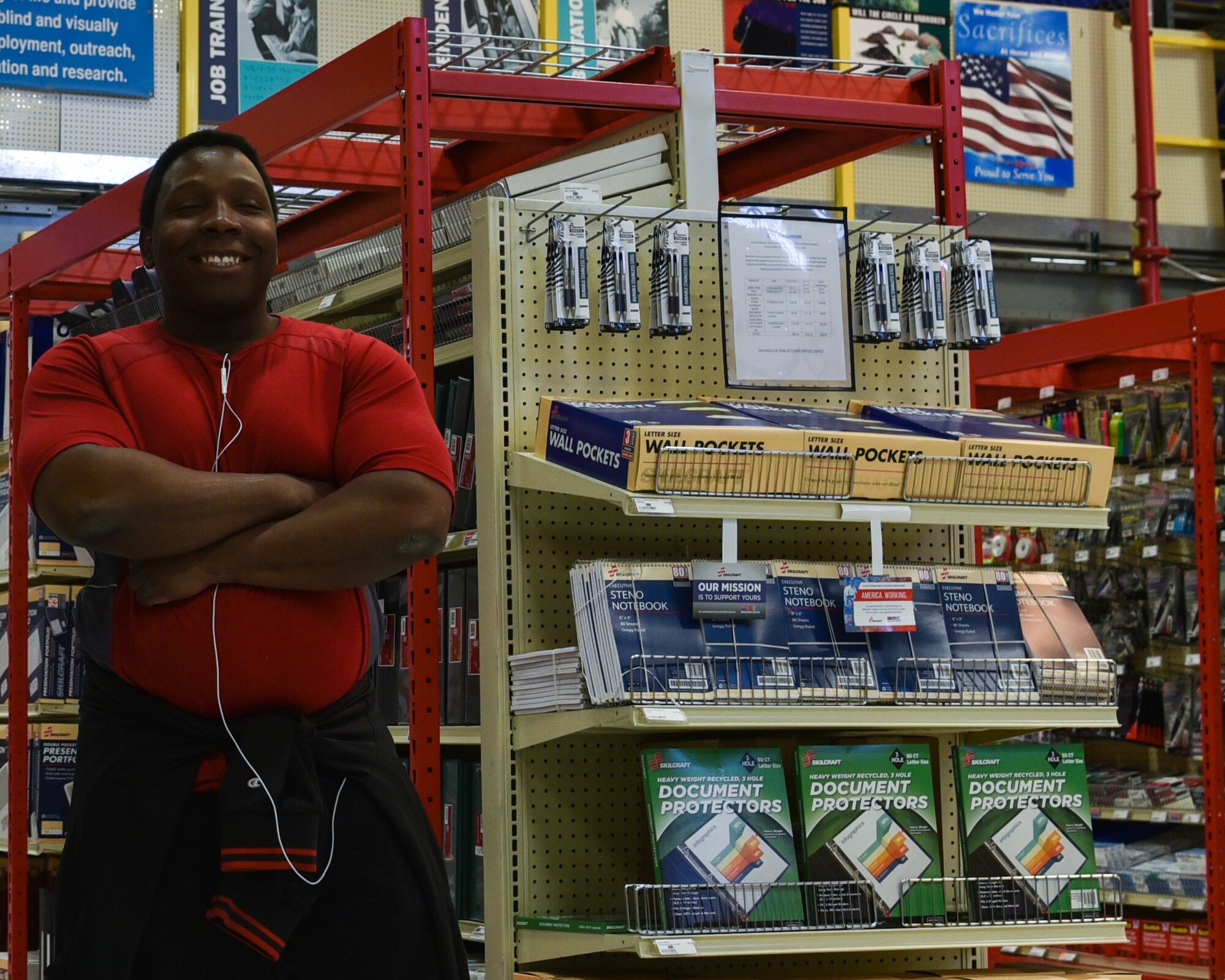 AJ Wheeler, F.E. Warren Air Force Base, Wyo., Envision Xpress stocker and cashier, crosses his arms after stocking a shelf, June 5, 2019, on F.E Warren Air force Base, Wyo.