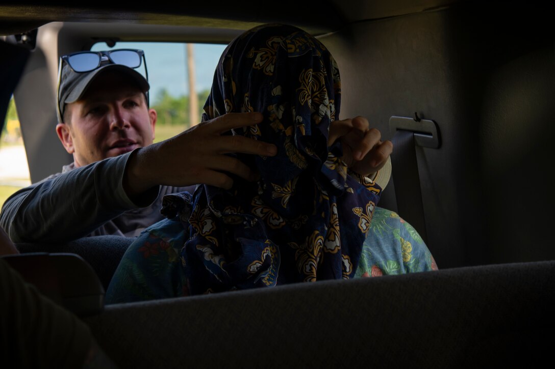 Tech. Sgt. Saul Grosshuesch, a 302nd Airlift Wing Survival Evasion Resistance and Escape candidate, blindfolds a 302nd AW aircrew member urban survival training portion of a three-day Survival Evasion Resistance and Escape refresher training in Key West, Florida, May 23, 2019. (U.S. Air Force photo by Tech. Sgt. Frank Casciotta)