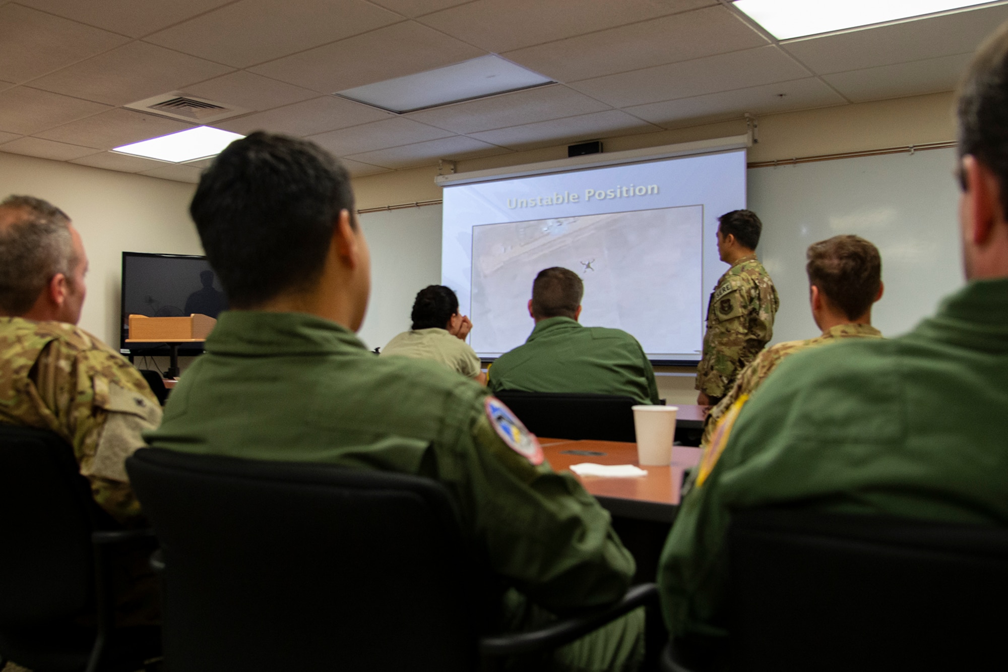 Tech. Sgt. Tony Fancher, a 302nd Airlift Wing Survival Evasion Resistance and Escape instructor, goes over emergency parachute procedures with members of the 731st Airlift Squadron and 34th Aeromedical Evacuation Squadron during a three-day Survival Evasion Resistance and Escape refresher training in Key West, Florida, May 23, 2019. (U.S. Air Force photo by Tech. Sgt. Frank Casciotta)