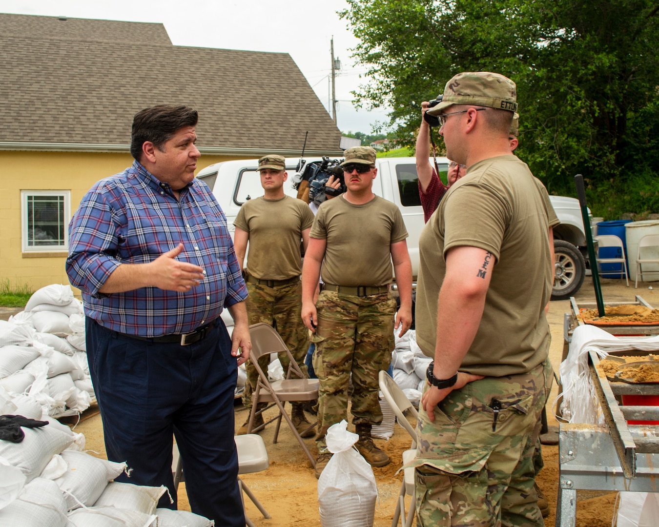 Illinois Gov. J.B. Pritzker talks with Soldiers of Battery B, 2nd Battalion, 123rd Field Artillery during a tour of flooding around Grafton, Illinois