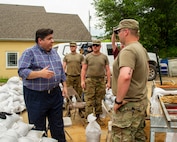 Illinois Gov. J.B. Pritzker talks with Soldiers of Battery B, 2nd Battalion, 123rd Field Artillery during a tour of flooding around Grafton, Illinois